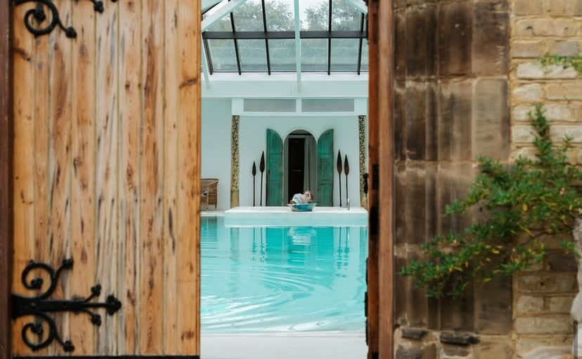 Old wooden doors opening onto the pool