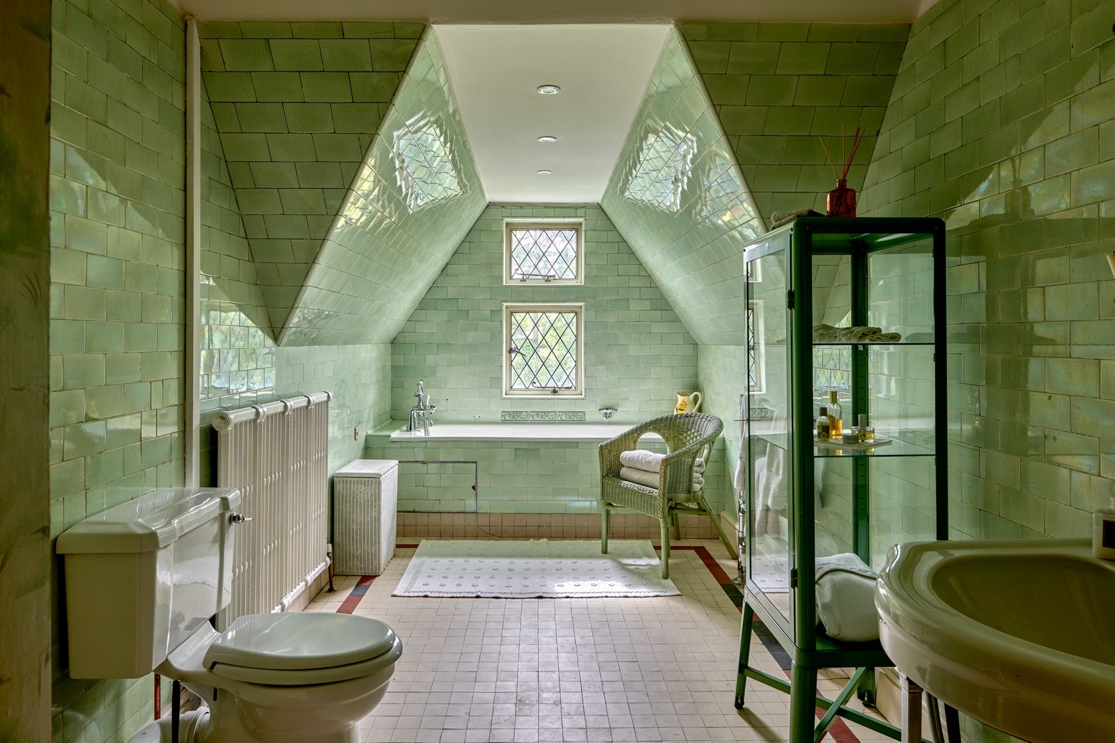 Green-tiled bathroom under the eaves