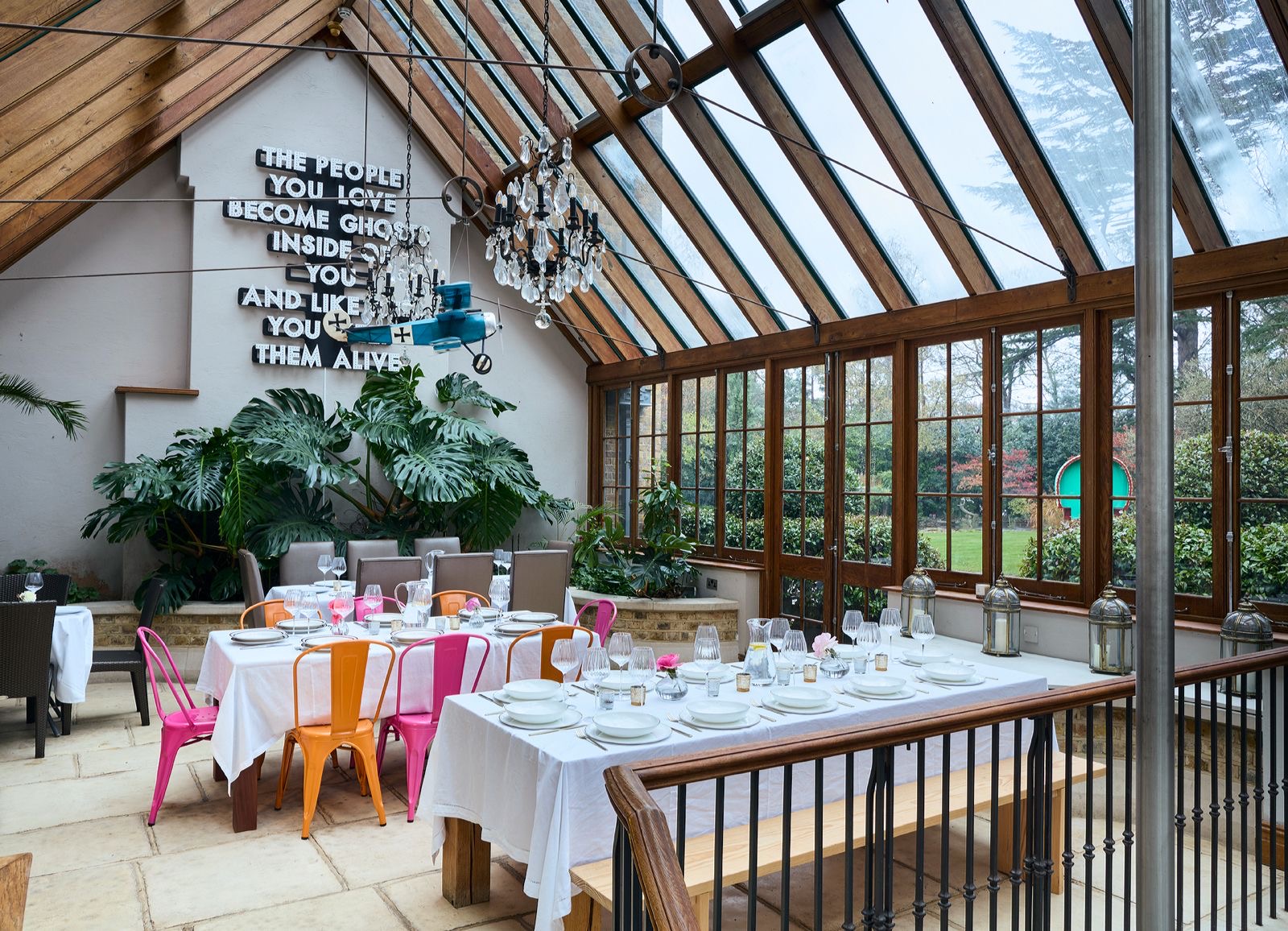 The conservatory, full of light, set with long tables