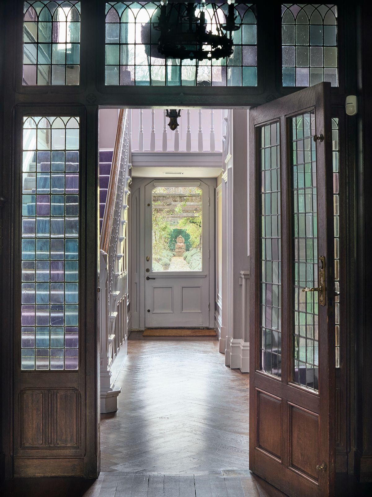 Stained-glass doors opening onto the entrance hall