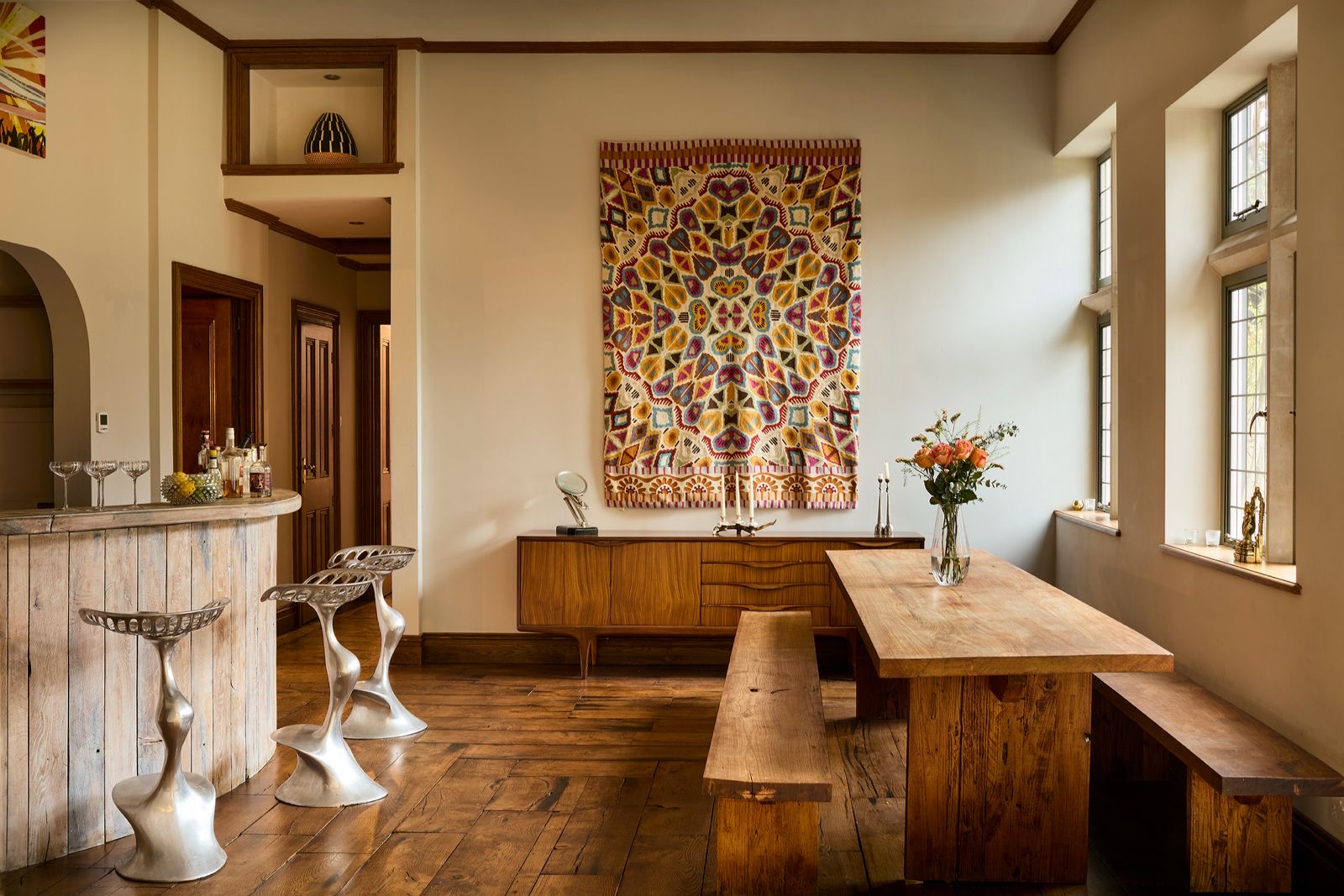 The kitchen and bar with a long wooden table and benches